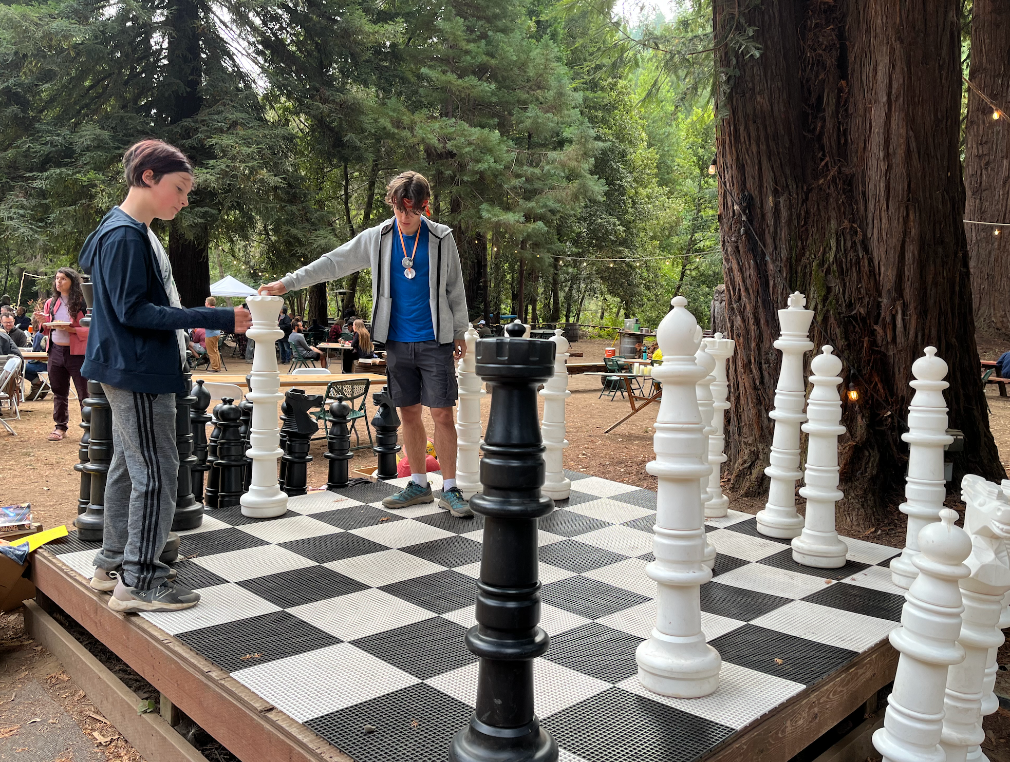 Ryder Morton playing giant chess against his younger brother Hunter in 2024.